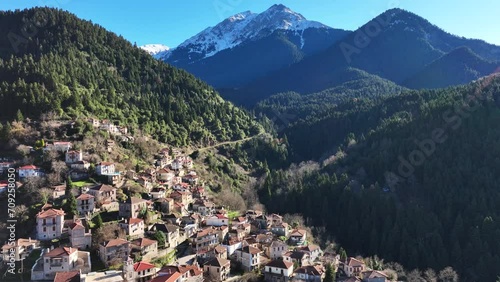 Aerial drone cinematic video of iconic small traditional village of Megalo Chorio built on a mountain slope near famous village of Karpenissi, Evrytania, Greece photo