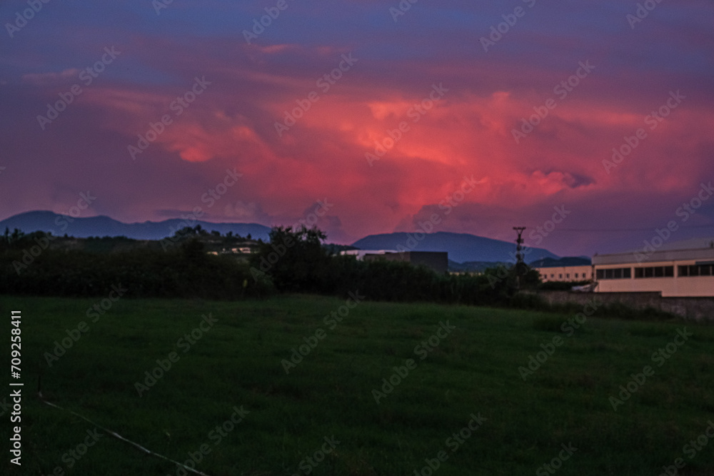 Beautiful sunset sky above clouds with dramatic light. Cabin view from car.