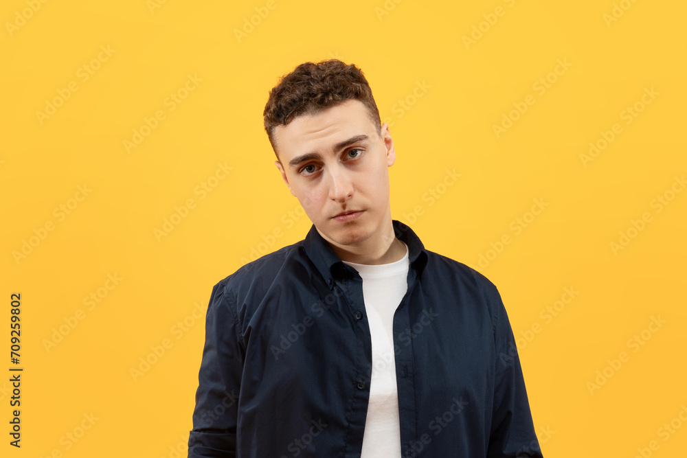 Young sad furious man wearing casual clothes looking at camera Young sad furious man wearing casual clothes looking at camera
