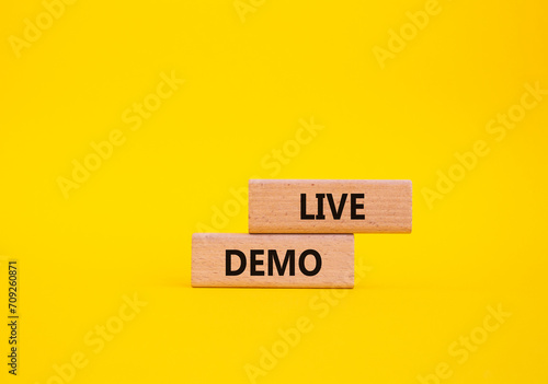 Live Demo symbol. Concept word Live Demo on wooden blocks. Beautiful yellow background. Business and Live Demo concept. Copy space