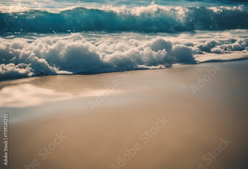 Soft waves with foam blue ocean sea on a golden sunny sandy beach in resort on summer vacation rest