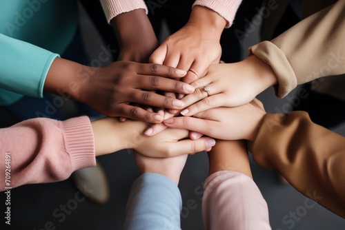 a diverse team stacking their hands in a circle