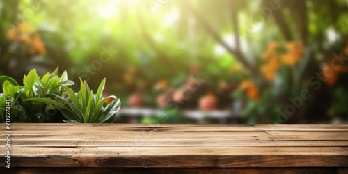 Wooden table over garden background for product presentation.