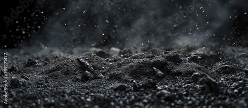 -rendered close-up of debris and dust on black backdrop.