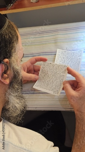 inside Mezuzah jewish Papyrus scroll Klaf inscribed with Hebrew verses from the sefer Torah Jewish mitzvah prayer Shema Yisrael photo
