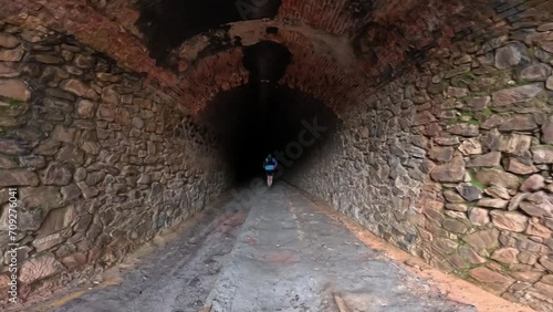 person walking in a tunnel