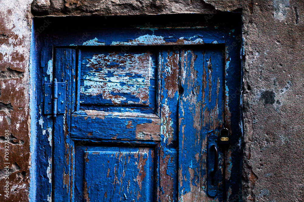 bright blue door close-up in daylight on an old building bright blue door close-up in daylight on an old building