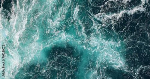 Blue waves of water of the river and the sea meet each other during high tide and low tide. photo