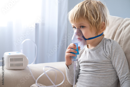 little boy using steam inhaler nebulizer. health medical care.