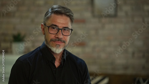 Foto Portrait of happy, confident older man at home looking at camera smiling