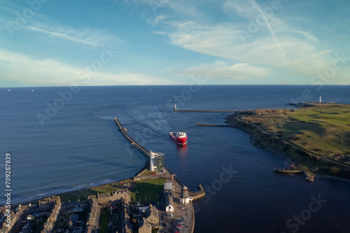 Ship arriving at Aberdeen harbour after passing Girdle Ness Lighthouse