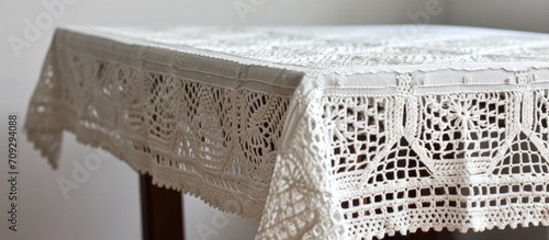 Vintage white crochet tablecloth with square motifs.