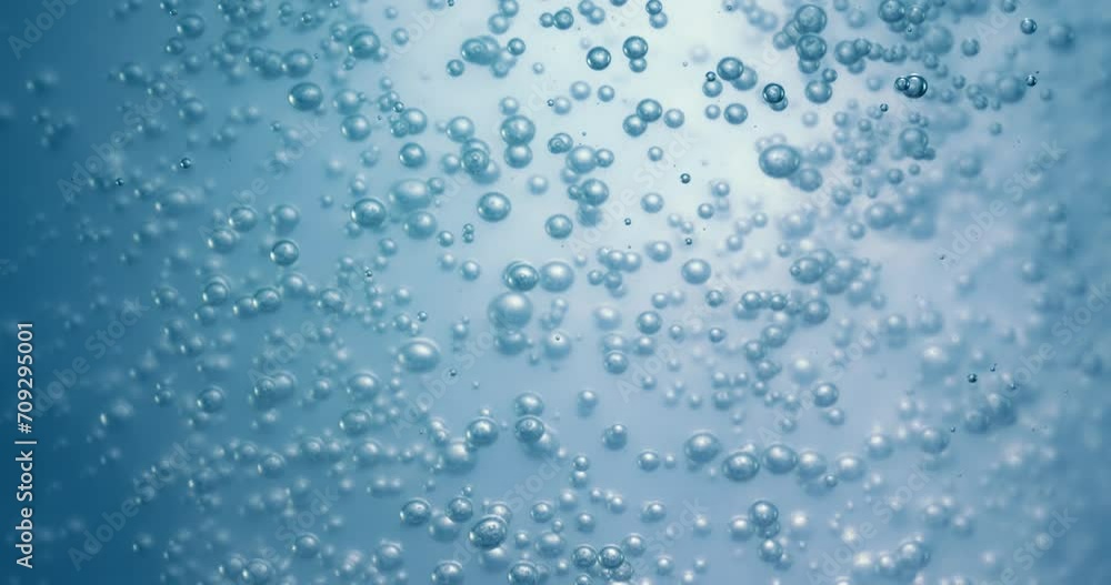 Many water bubbles in blue water close up, abstract water wave with bubbles in slow motion. Many water bubbles in blue water close up, abstract water wave with bubbles in slow motion.