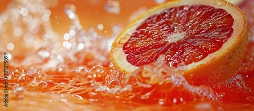 Close-up of a ripe, juicy fruit in water, resembling a blood-orange cocktail.
