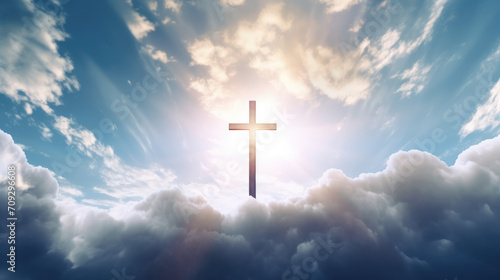 Jesus cross symbol on infinite sky background. Sky with clouds and sun rays with Christian cross in the middle - religious catholic background with copy space © EOL STUDIOS