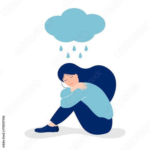 sad depressed girl sitting under a cloud with rain on a white background