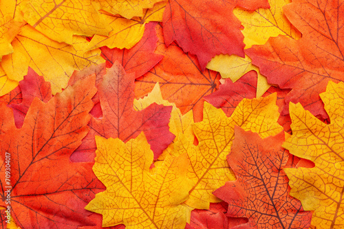 Composition with faux autumn leaves. Autumnal background