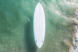 Aerial view of a white surfboard on the sea. Top view. Mockup. Editable Template. Surfboards on the beach. Vacation Concept.	