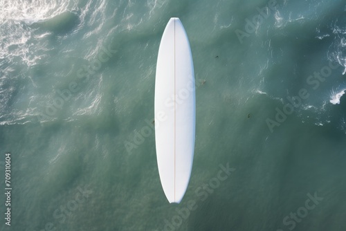 Aerial view of a Blank White Mockup of  surfboard on the ocean. Top view. Mockup. Editable Template. Surfboards on the beach. Vacation Concept.  © John Martin