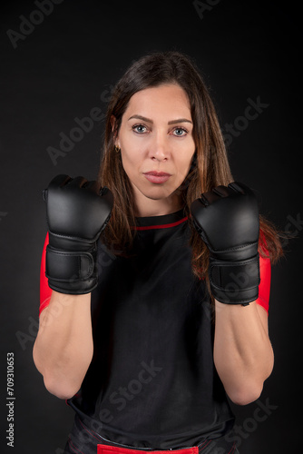 Caucasian MMA teacher posing and showing off strength, gloves © JuanMa