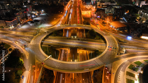 Aerial drone slow shutter night photo of illuminated urban elevated toll ring road junction and interchange overpass passing through Kifisias Avenue  Attica  Greece