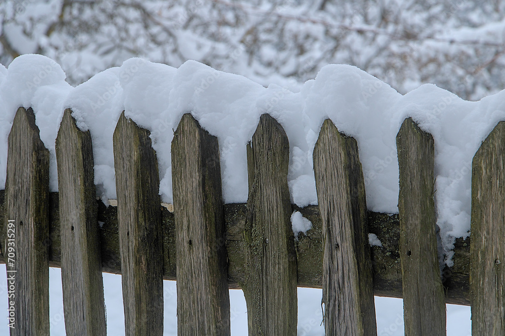 a wooden fence covered with snow a wooden fence covered with snow