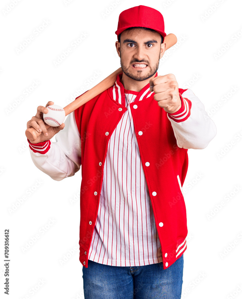 Young handsome man holding baseball bat and ball annoyed and frustrated shouting with anger, yelling crazy with anger and hand raised Young handsome man holding baseball bat and ball annoyed and frustrated shouting with anger, yelling crazy with anger and hand raised