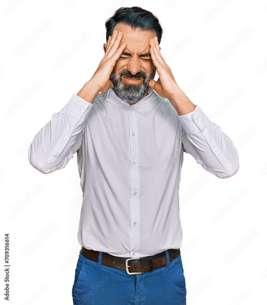 Middle aged man with beard wearing casual white shirt suffering from headache desperate and stressed because pain and migraine. hands on head. Middle aged man with beard wearing casual white shirt suffering from headache desperate and stressed because pain and migraine. hands on head.