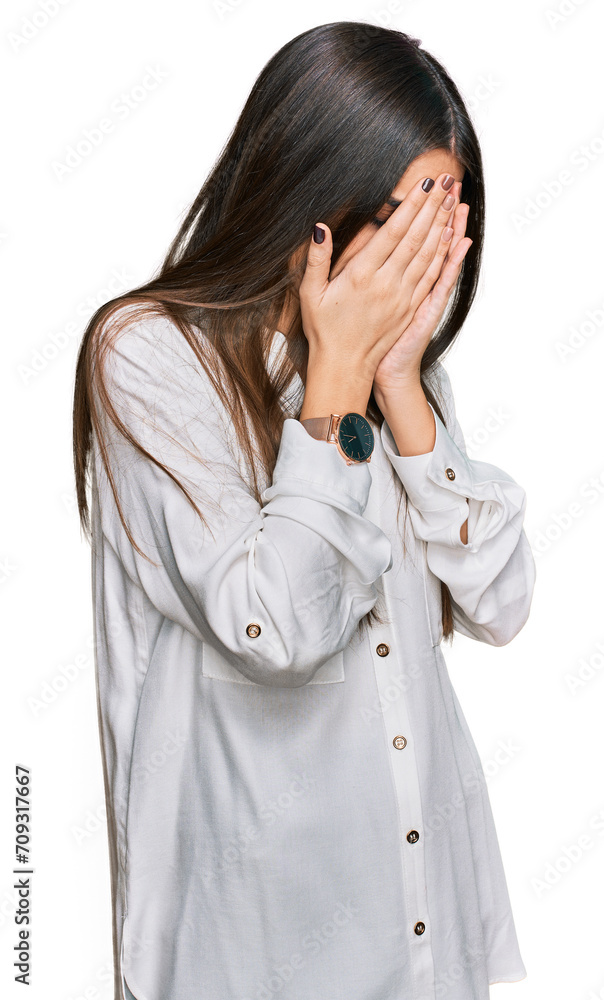 Young beautiful woman wearing casual white shirt with sad expression covering face with hands while crying. depression concept. Young beautiful woman wearing casual white shirt with sad expression covering face with hands while crying. depression concept.