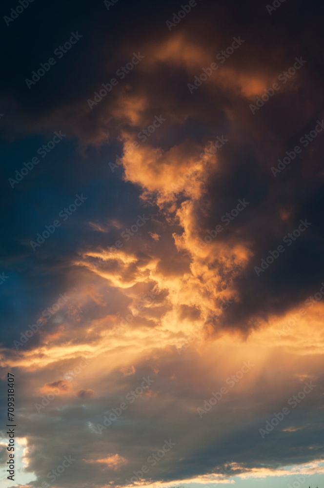Abstract colorful background. Beautiful red sunset over a small town. Dramatic sunset sky with clouds.
