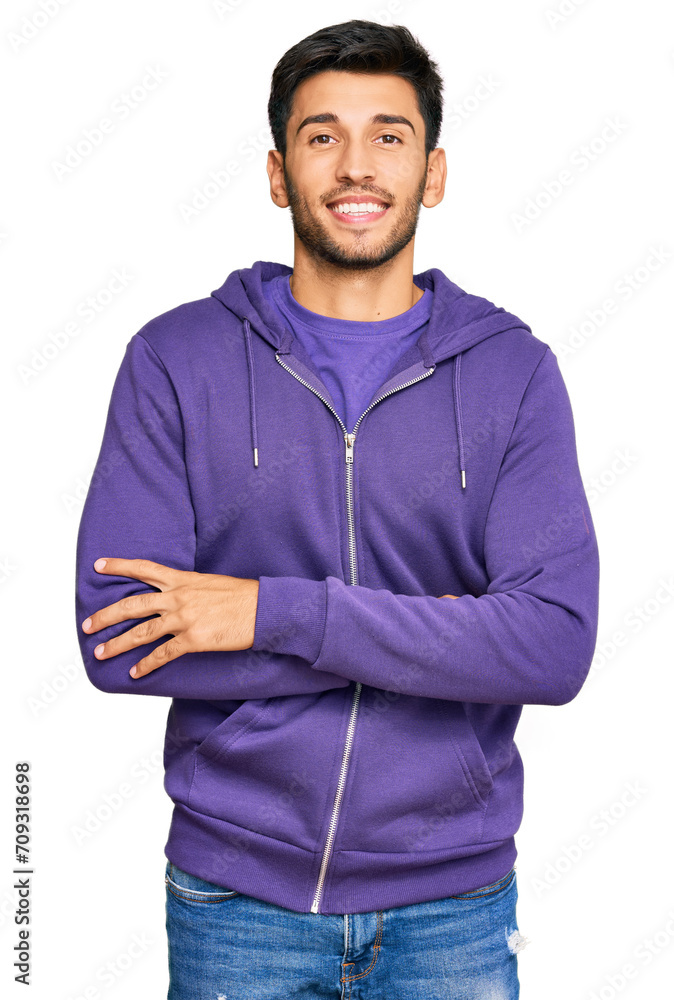 Young handsome man wearing casual sweatshirt happy face smiling with crossed arms looking at the camera. positive person. Young handsome man wearing casual sweatshirt happy face smiling with crossed arms looking at the camera. positive person.