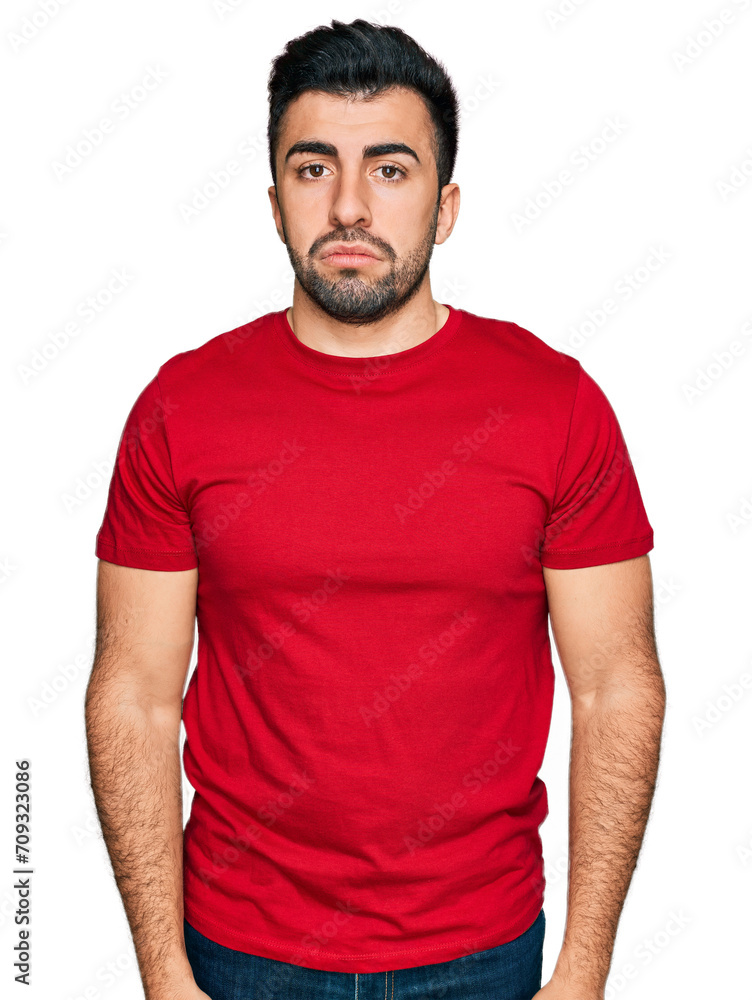 Hispanic man with beard wearing casual red t shirt depressed and worry for distress, crying angry and afraid. sad expression. Hispanic man with beard wearing casual red t shirt depressed and worry for distress, crying angry and afraid. sad expression.