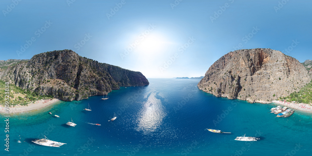 Panoramic view of the Butterfly Valley (Kelebekler Vadisi). Turquoise bay with a beach surrounded by mountains. Fethiye/Oludeniz, Mugla Province, Turkey. Aerial seamless spherical 360 degree panorama