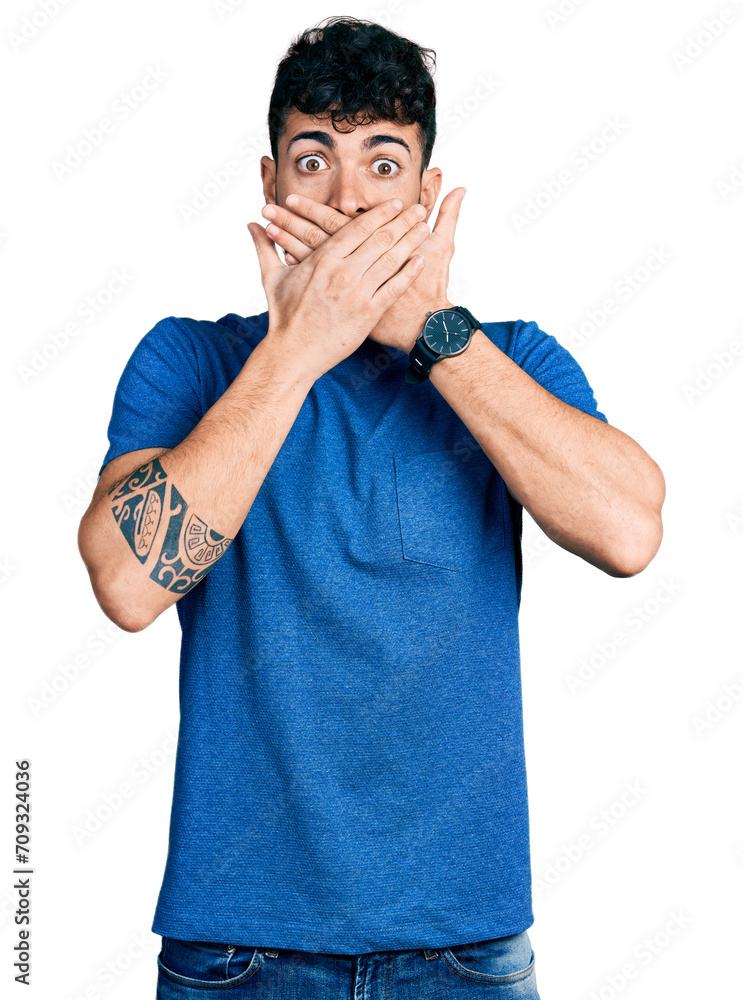 Young hispanic man wearing casual t shirt shocked covering mouth with hands for mistake. secret concept. Young hispanic man wearing casual t shirt shocked covering mouth with hands for mistake. secret concept.