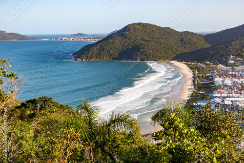 Brava beach with forest and buildings,