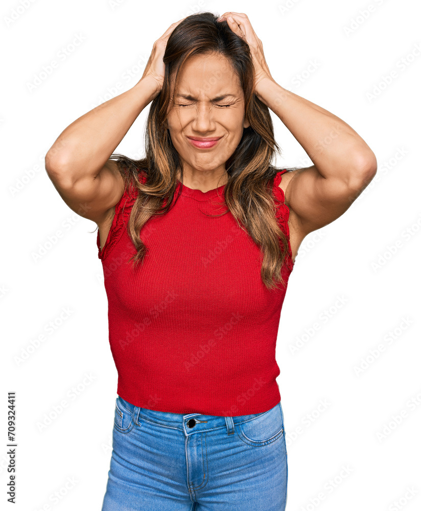 Young hispanic woman wearing casual clothes suffering from headache desperate and stressed because pain and migraine. hands on head. Young hispanic woman wearing casual clothes suffering from headache desperate and stressed because pain and migraine. hands on head.