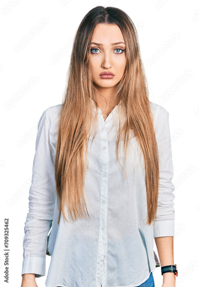 Beautiful caucasian woman wearing casual white shirt depressed and worry for distress, crying angry and afraid. sad expression. Beautiful caucasian woman wearing casual white shirt depressed and worry for distress, crying angry and afraid. sad expression.