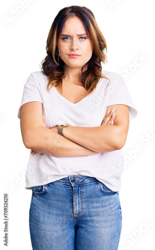 Young beautiful caucasian woman wearing casual white tshirt skeptic and nervous, disapproving expression on face with crossed arms. negative person.