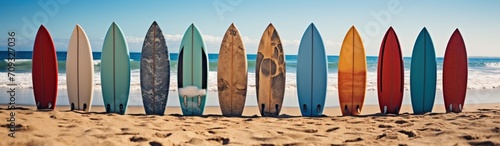 Surfboards on the beach at sunset. Colorful surfboards background. Surfboards with abstract pattern. Surfboards on the beach. Vacation Concept. Panoramic banner with copy space. © John Martin