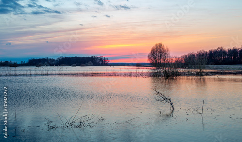 Rural flooding at sunset, flooded farmland