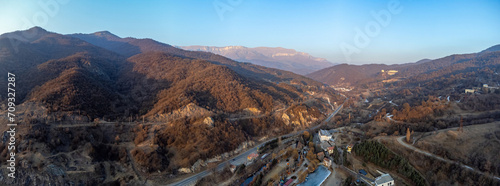 The nature of Armenia. Mountain ranges and highways. The surroundings of the tourist city of Dilijan. Panorama of the city in Armenia from a drone. Republic of Armenia