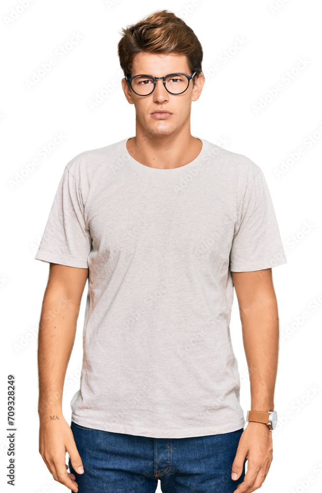 Handsome caucasian man wearing casual clothes and glasses relaxed with serious expression on face. simple and natural looking at the camera. Handsome caucasian man wearing casual clothes and glasses relaxed with serious expression on face. simple and natural looking at the camera.