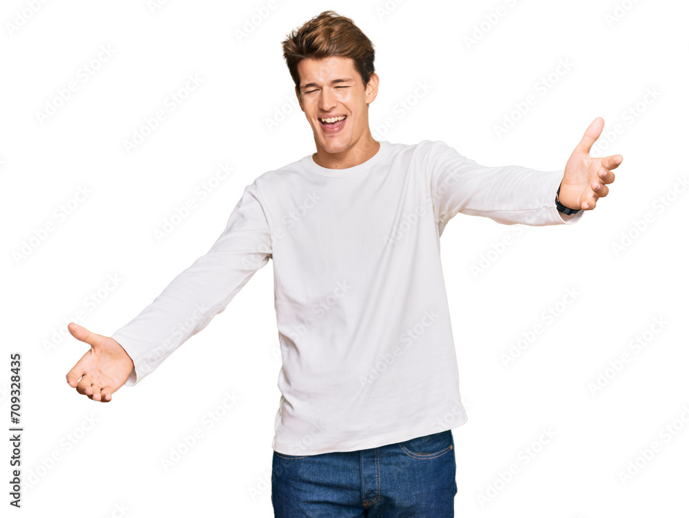 Handsome caucasian man wearing casual white sweater looking at the camera smiling with open arms for hug. cheerful expression embracing happiness. Handsome caucasian man wearing casual white sweater looking at the camera smiling with open arms for hug. cheerful expression embracing happiness.
