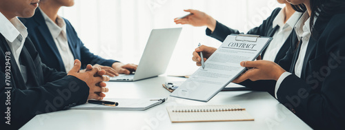 Two business executive in boardroom discuss term and company merging agreement, review corporate contract document as business partnership and cooperation with acquisition and merger concept. Shrewd photo