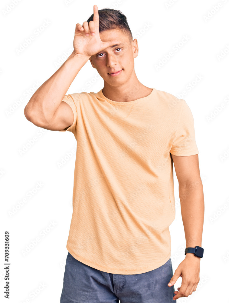 Young handsome man wearing casual clothes making fun of people with fingers on forehead doing loser gesture mocking and insulting. Young handsome man wearing casual clothes making fun of people with fingers on forehead doing loser gesture mocking and insulting.