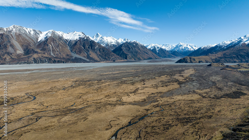 Naklejka premium Drone photo of the arid desert like Hakatere Valley and southern alps in the Ashburton Highlands