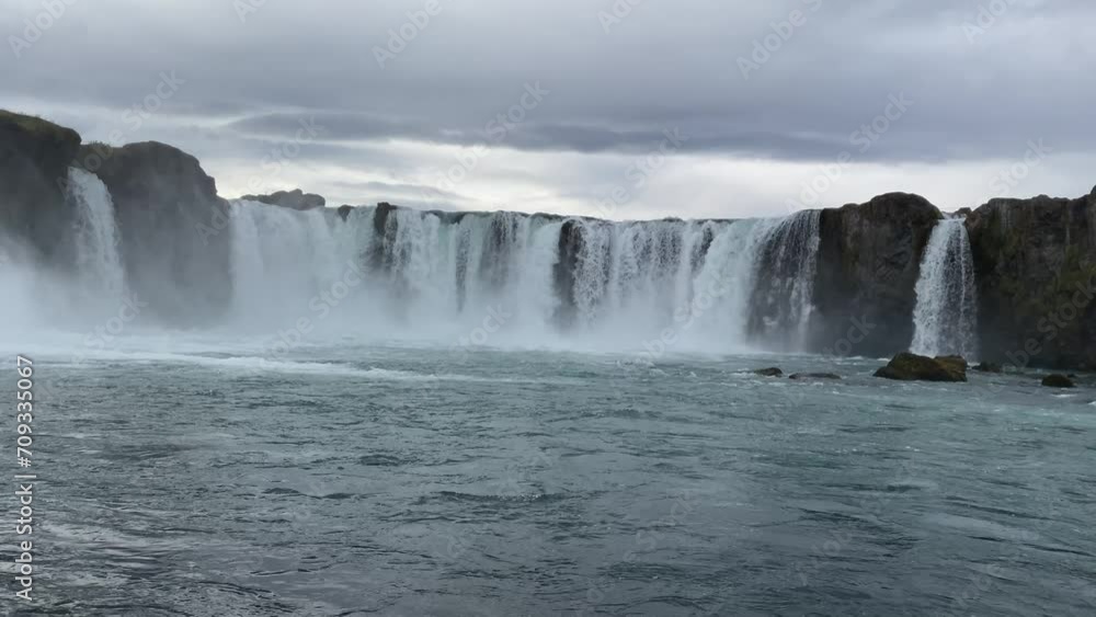 Traveling and exploring Iceland landscapes and famous places. Autumn tourism by Atlantic ocean and mountains. Outdoor views on beautiful cliffs and travel destinations. Godafoss waterfall. Traveling and exploring Iceland landscapes and famous places. Autumn tourism by Atlantic ocean and mountains. Outdoor views on beautiful cliffs and travel destinations. Godafoss waterfall.