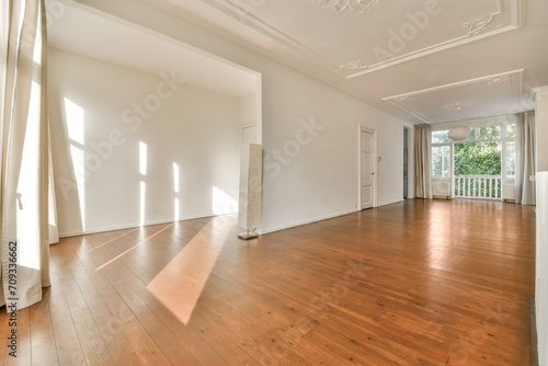 Spacious empty room with hardwood floors and natural light photo