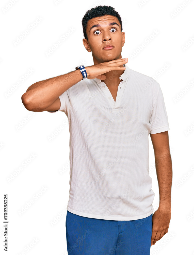 Young arab man wearing casual clothes cutting throat with hand as knife, threaten aggression with furious violence Young arab man wearing casual clothes cutting throat with hand as knife, threaten aggression with furious violence