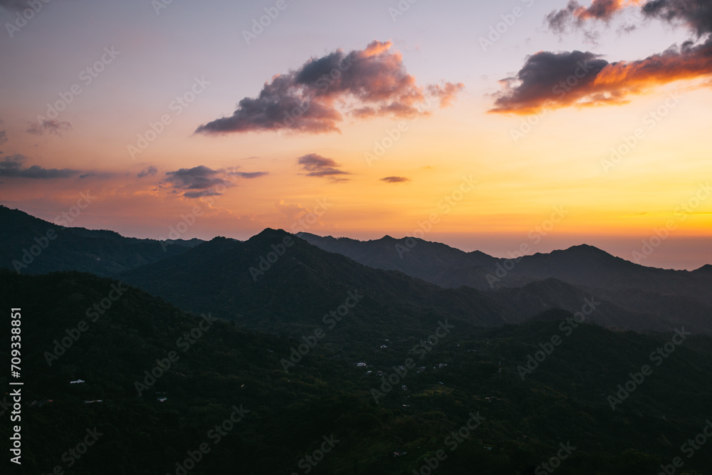 Mountain sunset with orange-hued skies in Minca, Colombia Mountain sunset with orange-hued skies in Minca, Colombia